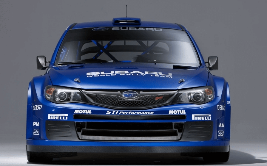 Front view of a blue Subaru rally car showcasing its iconic design and sponsor logos.