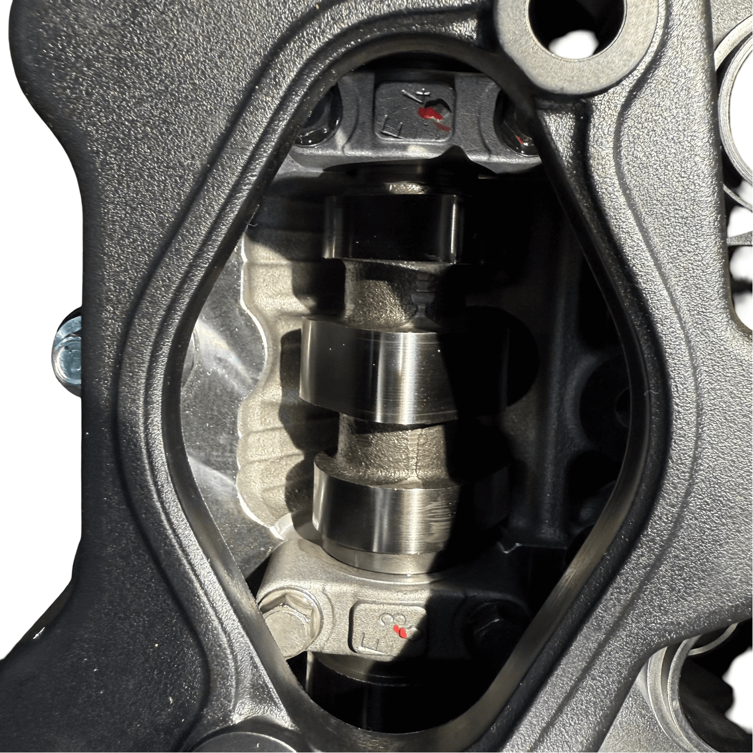 Close-up view of the camshaft inside a Kia Sportage 2.4L engine showing precision engineering.