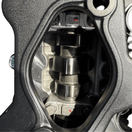 Close-up view of the camshaft inside a Kia Sportage 2.4L engine showing precision engineering.